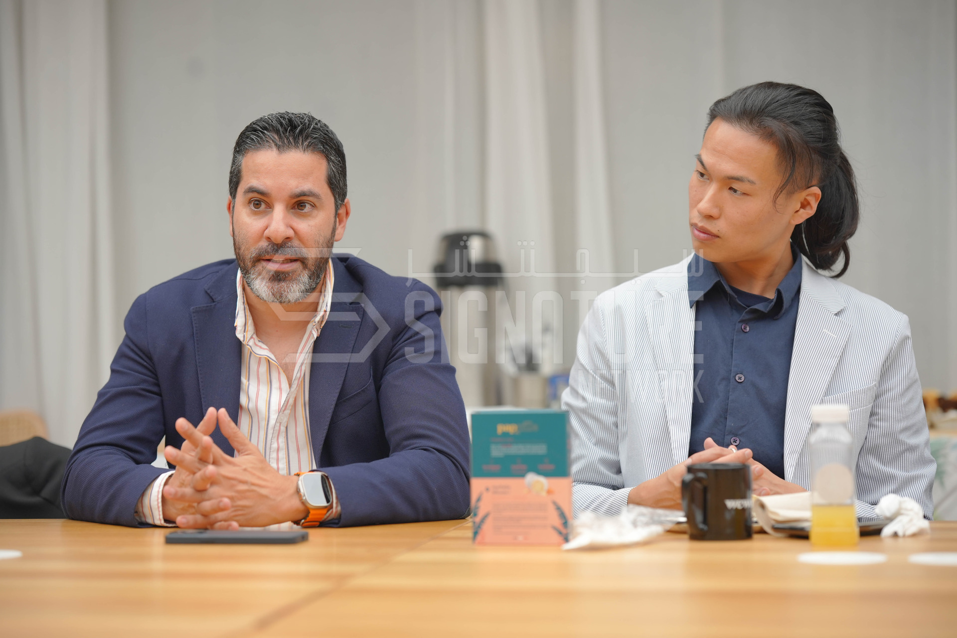 Two employees seated at a table.